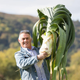 Man holds up giant leek
